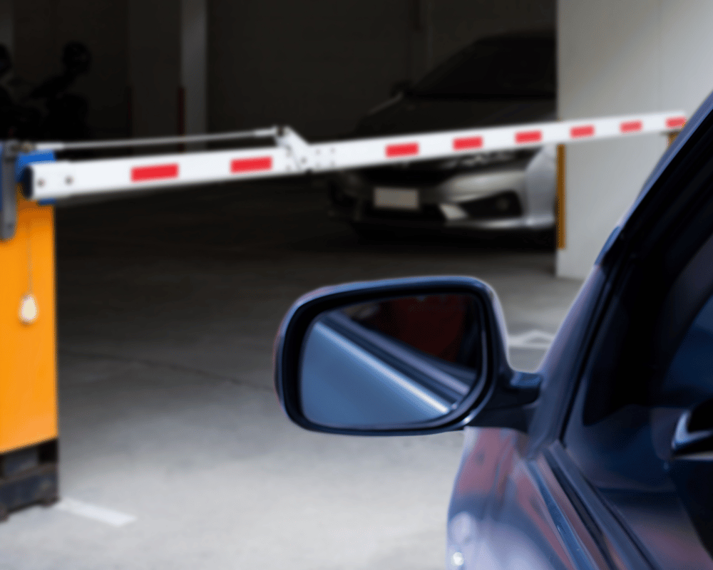 car at parking garage barrier gate